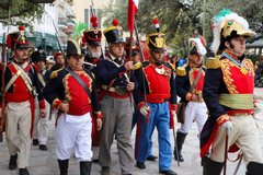 Living historians dressed as Mexican soldiers marching in a group