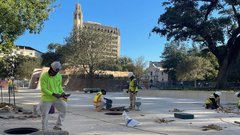 Construction workers over pot holes in Mission Gate area