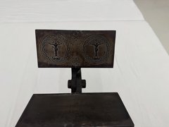 Iron press open to show both sides, with one side showing Jesus on the cross etched on either side