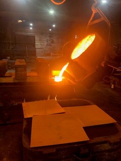 Molten metal being poured into a mold