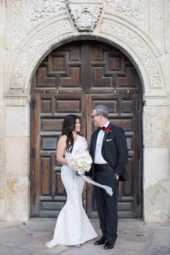 Bride and groom outside of door of Alamo Church