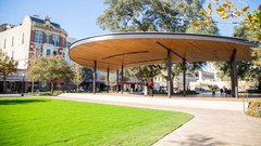 Covered pavilion stage in front of large grass area