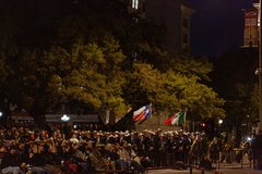 Crowd of visitors both seated and standing in Alamo Plaza