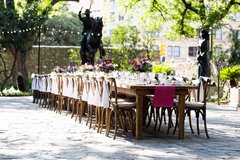 Farmhouse table set in Cavalry Courtyard in front of bronze statue