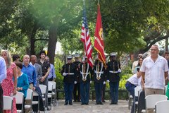Marines prepared to march, holding the American flag and the Marines flag