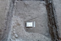 Dirt and limestone surface at bottom of excavation unit