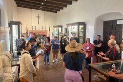 Group of teachers listening to a guide inside a lobby area
