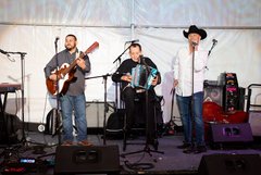 Nunie Rubio, Flaco Jimenez, and guitarist performing on stage at event