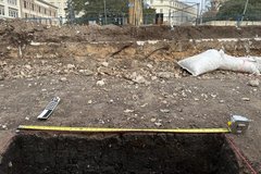 Ground above excavation unit with a fence
