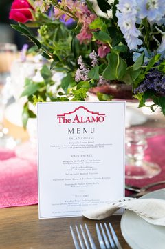 Menu standing against a floral centerpiece