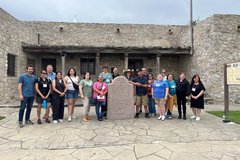 A group of teachers standing in front of Presido La Bahia