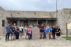 A group of teachers standing in front of Presido La Bahia