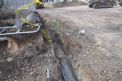 Utility trench along tree planter with conduit installed