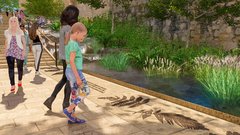 Child looking at drawings of leaves on the floor by a water feature