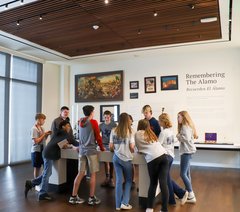 Children gathered around interactive table in gallery