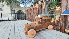 Side view of bronze cannon on a wooden carriage on Alamo Palisade