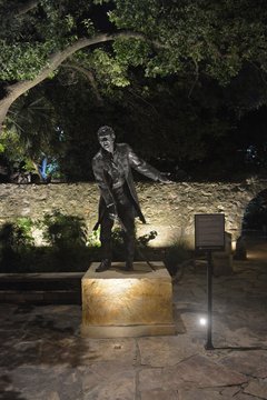 Statue of William Barret Travis lit up at night