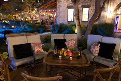 Seating around with black and pink pillows set up just outside Alamo Hall