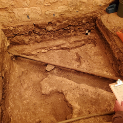 Flooring constructed of compacted caliche in excavation unit