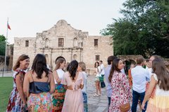 Group of guests gathered in front of Alamo Church