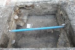 Blue pipe across an excavation unit