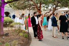 Guests mingling under a tree in Convento Courtyard