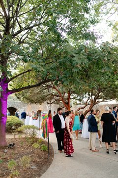 Guests mingling under a tree in Convento Courtyard