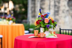 Cocktail table with red linens and colorful flowers