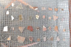 Range of ceramic fragments laid on a wire screen