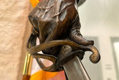 Detail of hand holding sword on bronze statue of Lt. Colonel William Barret Travis