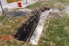 Dug out trench facing west in a grassy area