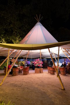 Large tent with bar and seating set up in Alamo Gardens