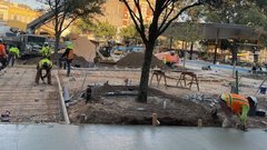 Construction workers installing pavers in Plaza de Valero