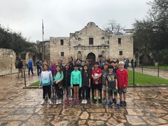 Children on a field trip in front of Alamo Church