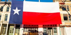 Large Texas flag over a building