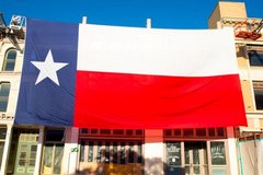 Large Texas flag over a building