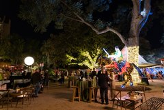 Guests mingling in Alamo Gardens around lighted installation of Juan Seguin on horseback