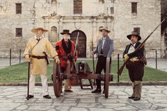 Four Living Historians with a cannon in front of Alamo Church