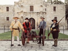 Four Living Historians with a cannon in front of Alamo Church