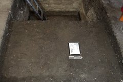 Flat, dirt surface at the bottom of an excavation unit