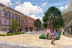 Outdoor pedestrian area with people in front of a tree and statue