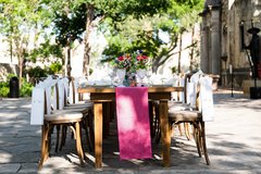 Farmhouse table set with pink runner and wildflower arrangement