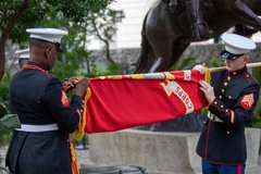 Marines taking down Marines flag at the close of a ceremony