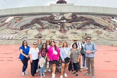Group of educators in front of a concrete art installation in Mexico City