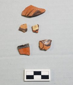 Pieces of brick colored ceramics with decorative swirls