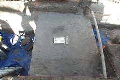 Grey, ashy deposit in an excavation unit