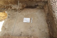 Smooth bottom surface inside an excavation unit with a rocky border