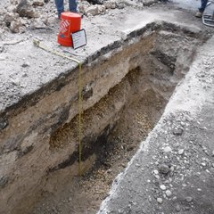 Excavation area with tape measure wrapped to bottom