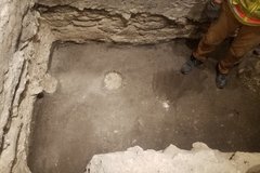 Two round post holes inside of an excavation unit