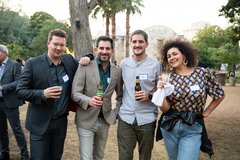 Four guests smiling at an event in Alamo Gardens
